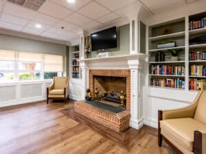 Fire place with a TV and windows at Greenville Post Acute