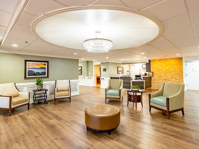 Lobby at Greenville Post Acute with seating area and wooden floors